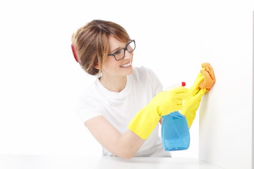 Cleaner wearing PPE while assessing a carpeted room for hazards